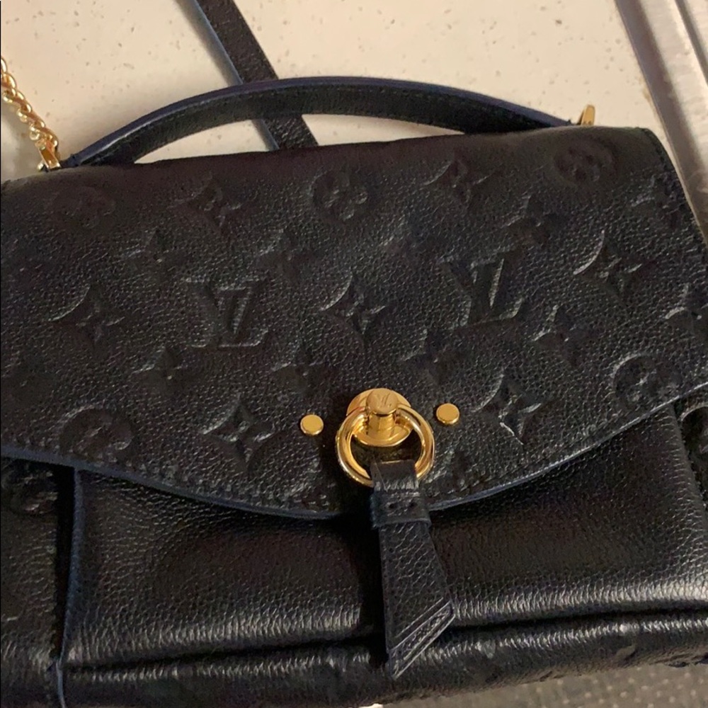 Purse looks black/navy gold hard ware